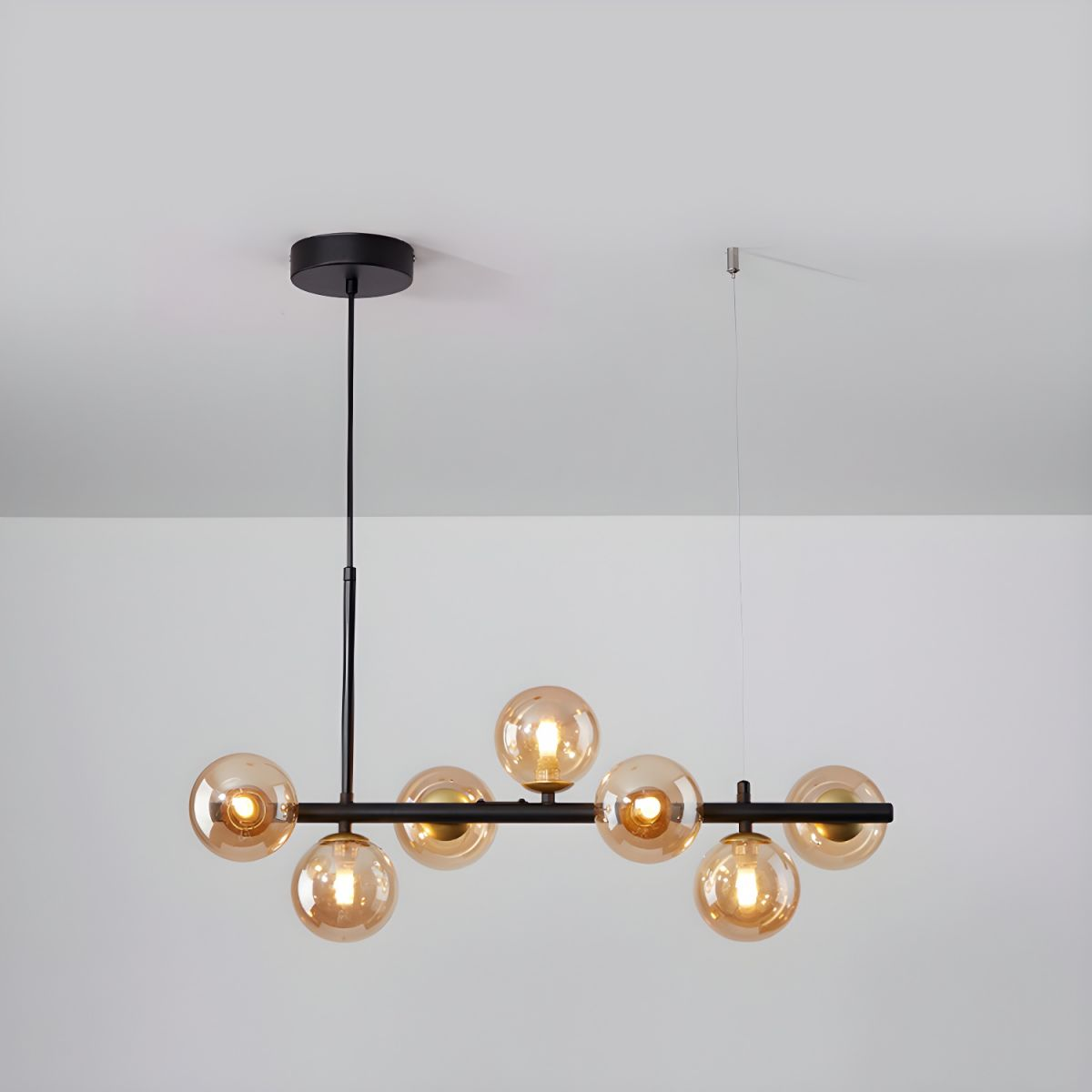 Modern chandelier with adjustable height featuring 11 glass globes and a black metal frame, ideal for living rooms and dining areas. 0
