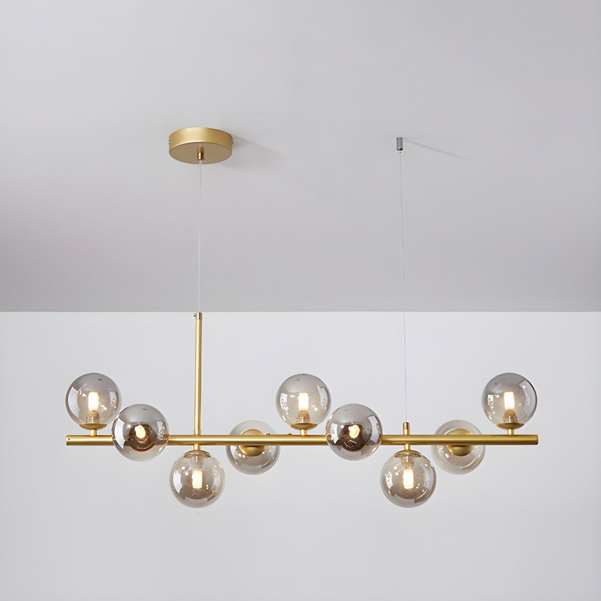 Modern chandelier with adjustable height featuring 11 glass globes and a black metal frame, ideal for living rooms and dining areas. 10