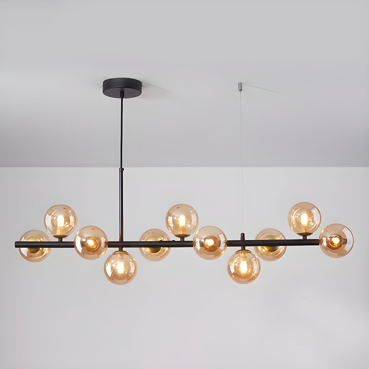 Modern chandelier with adjustable height featuring 11 glass globes and a black metal frame, ideal for living rooms and dining areas. 11