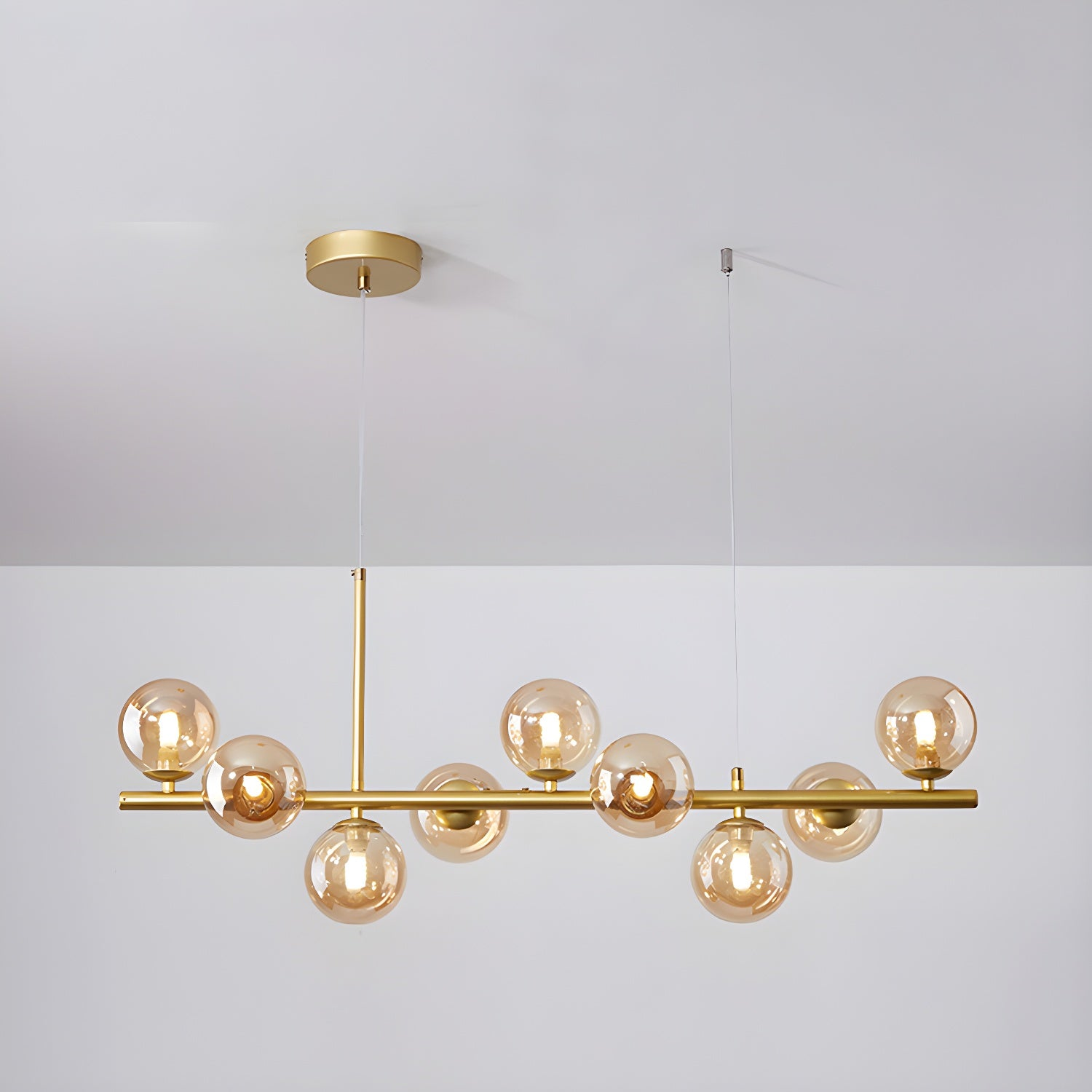 Modern chandelier with adjustable height featuring 11 glass globes and a black metal frame, ideal for living rooms and dining areas. 16
