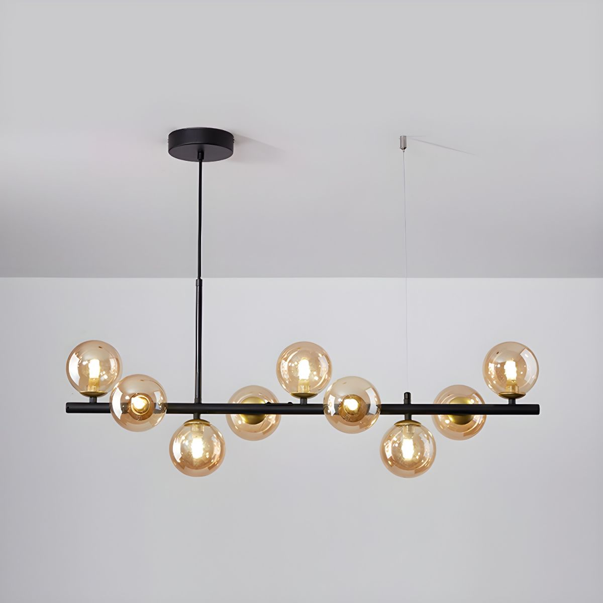 Modern chandelier with adjustable height featuring 11 glass globes and a black metal frame, ideal for living rooms and dining areas. 6